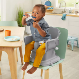 Toddler in a booster seat of a convertible high chair