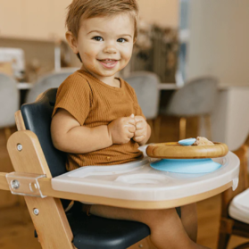 Toddler in high chair, staying safe by following a few guidelines