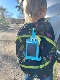 TekFun tablet attached to a backpack of little boy outside.
