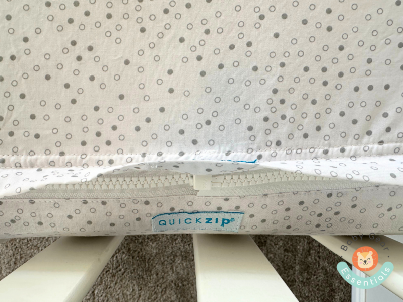 Close-up of the QuickZip Crib Sheet Set installed with zipper tucked in