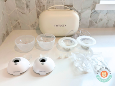 Momcozy M5 Breast Pump on the counter with all the parts separated