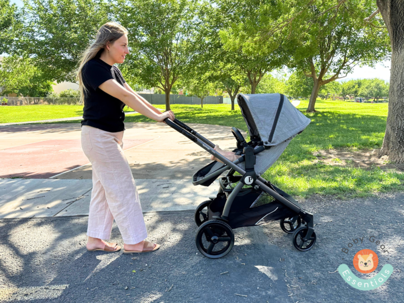 Mom pushing baby in a Peg Perego Ypsi travel system stroller outside
